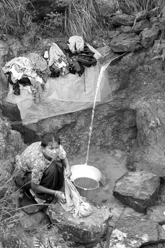 Traditional water supply science and technology of India - spring being used for domestic purposes by a Khasi tribal woman in Sohra (Cherrapunji), East Khasi Hills district, Meghalaya